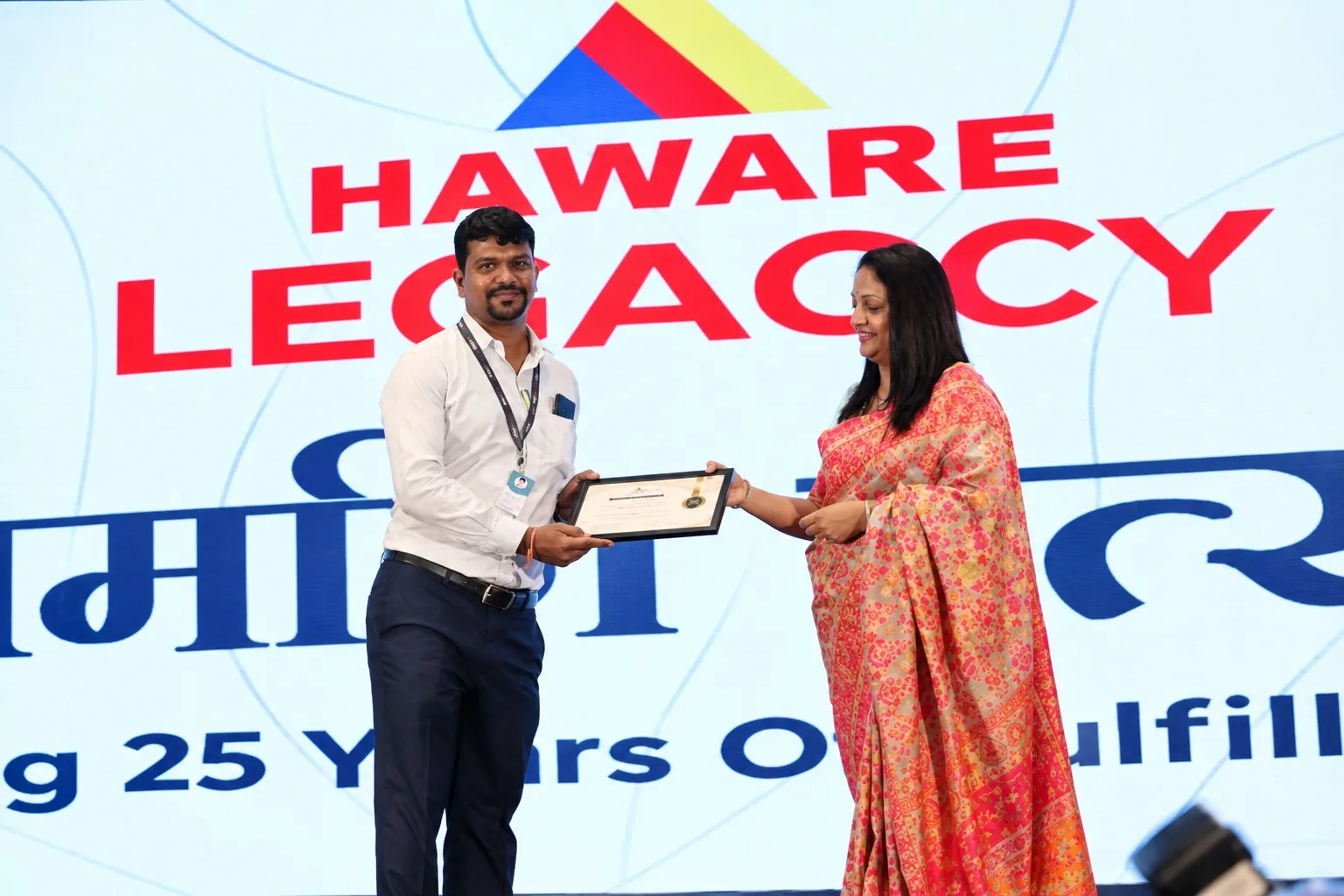 Certificate for sales performance being presented by Ujjwala Haware of Haware Legaccy